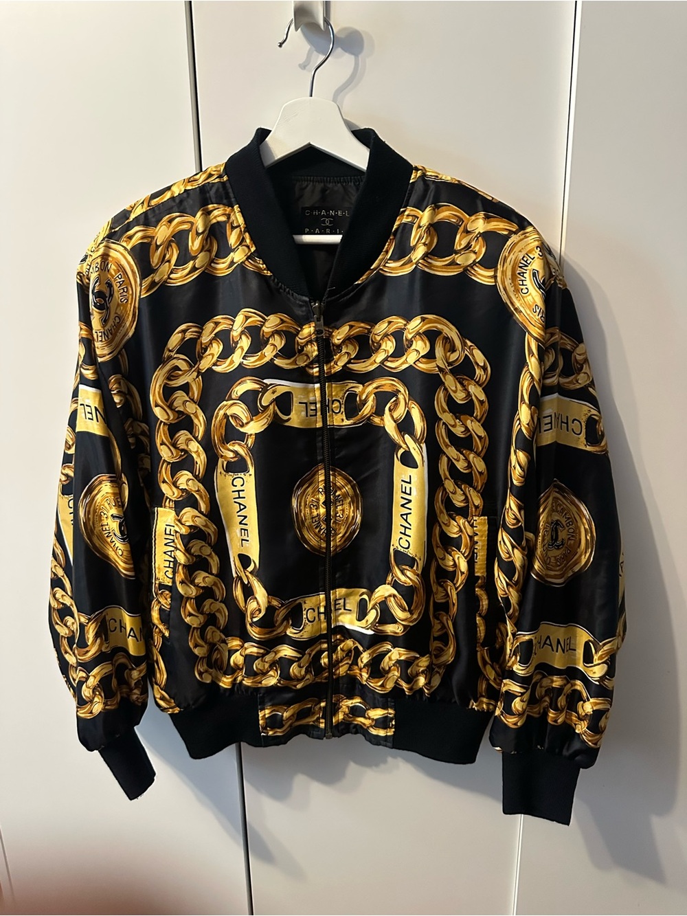 1990’s CHANEL Bootleg Black Bomber Jacket with Gold Chain & Medallion Print